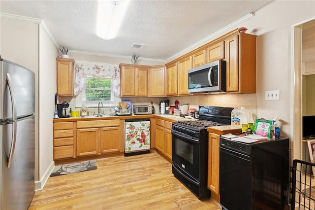 72433 Bullard St, Covington, LA 70435 - kitchen featuring appliances with stainless steel finishes, ornamental molding, light countertops, light wood-style floors, and a textured ceiling