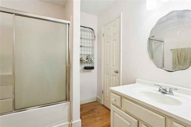 72433 Bullard St, Covington, LA 70435 - bathroom featuring vanity, wood finished floors, and shower / bath combination with glass door