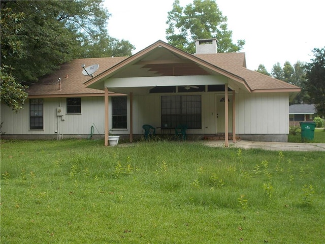 2112 Hamilton St, Franklinton, LA 70438 - back of house with a chimney, a lawn, and roof with shingles
