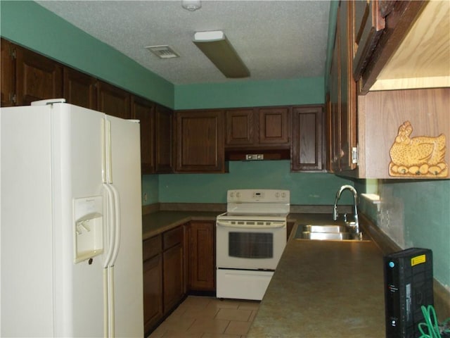 2112 Hamilton St, Franklinton, LA 70438 - kitchen featuring white appliances, under cabinet range hood, light tile patterned flooring, and a textured ceiling