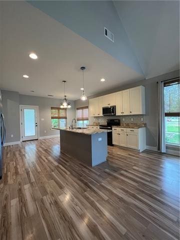 28623 Berry Todd Rd, Lacombe, LA 70445 - kitchen featuring stainless steel appliances, open floor plan, white cabinets, dark wood finished floors, and a chandelier