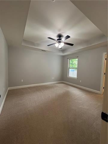 28623 Berry Todd Rd, Lacombe, LA 70445 - unfurnished room with carpet, a ceiling fan, and a tray ceiling