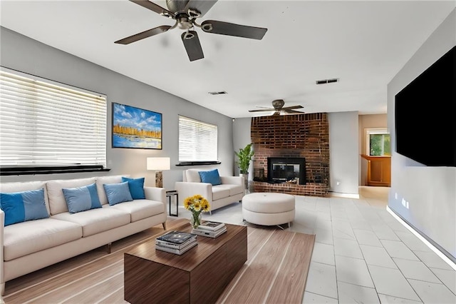 3109 Bayou View Pl, Slidell, LA 70458 - living area featuring ceiling fan, a fireplace, and plenty of natural light