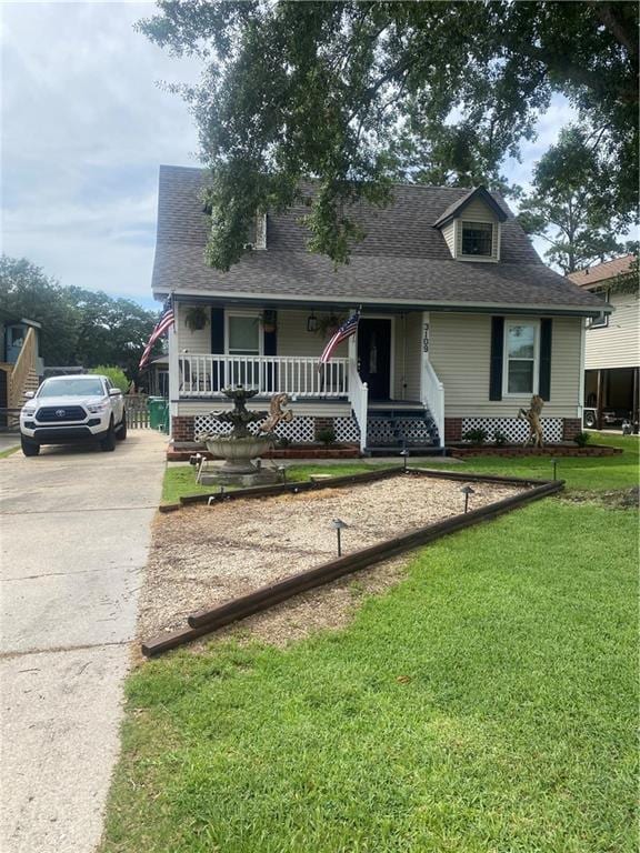 3109 Bayou View Pl, Slidell, LA 70458 - view of front facade with driveway, a porch, a front lawn, and roof with shingles