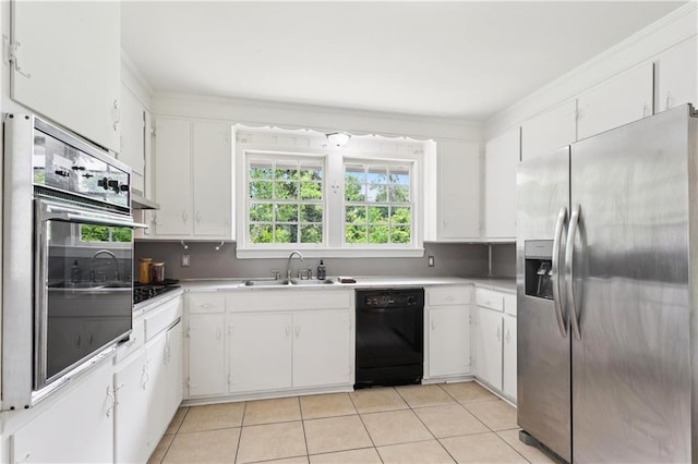 108 N Dr, Covington, LA 70433 - kitchen featuring black appliances, healthy amount of natural light, light tile patterned flooring, white cabinetry, and ornamental molding