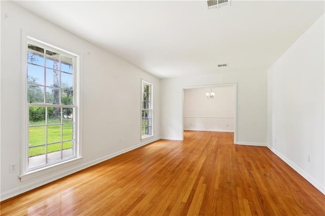 108 N Dr, Covington, LA 70433 - spare room with a chandelier, plenty of natural light, and light wood-style flooring