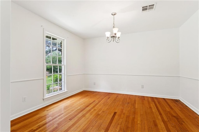 108 N Dr, Covington, LA 70433 - unfurnished room featuring a chandelier and wood-type flooring