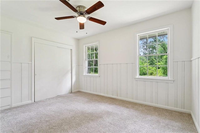 108 N Dr, Covington, LA 70433 - unfurnished bedroom featuring wainscoting, carpet floors, a closet, and ceiling fan