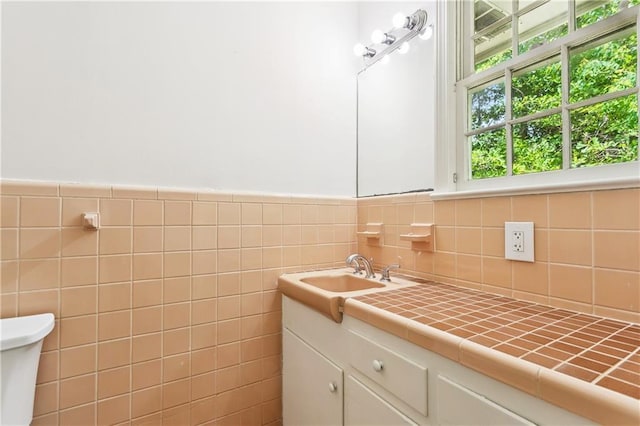 108 N Dr, Covington, LA 70433 - bathroom featuring vanity, tile walls, and a wainscoted wall
