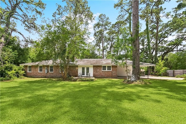 108 N Dr, Covington, LA 70433 - view of front of home featuring french doors, brick siding, an attached carport, and driveway