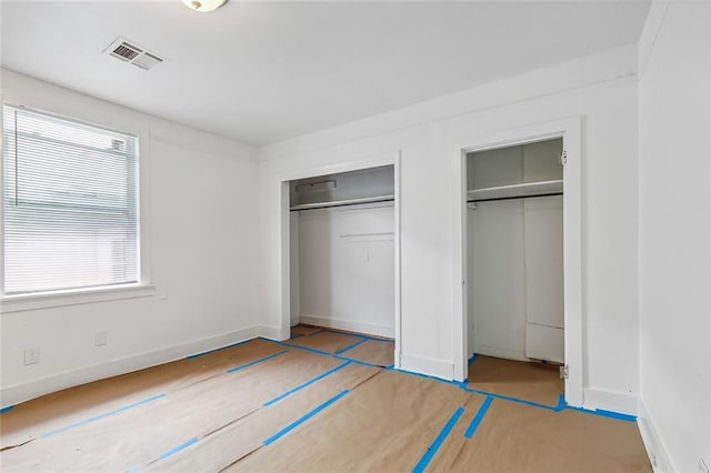 2232 Annette St, New Orleans, LA 70119 - unfurnished bedroom with multiple closets and baseboards