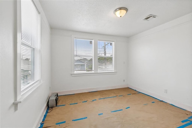 2232 Annette St, New Orleans, LA 70119 - spare room with a textured ceiling and baseboards
