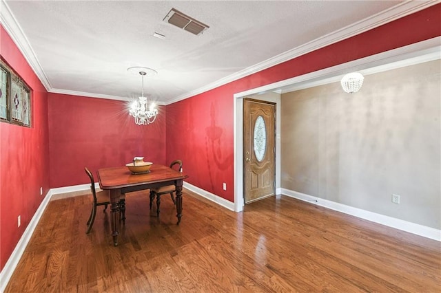 333 Bertolino Dr, Kenner, LA 70065 - dining room featuring wood finished floors, a chandelier, and ornamental molding