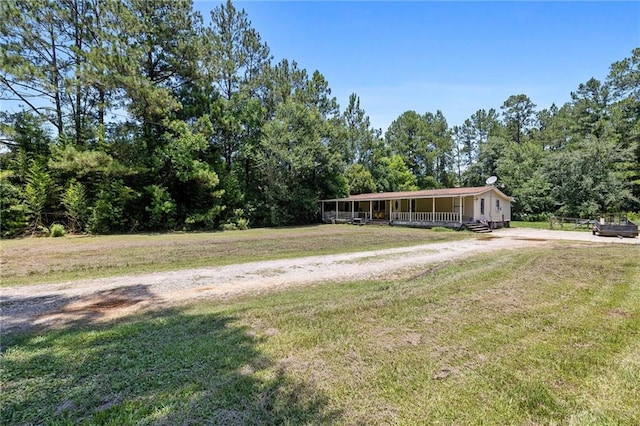 24473 Sanders Rd, Covington, LA 70435 - view of front of property featuring covered porch, a front yard, and a forest view