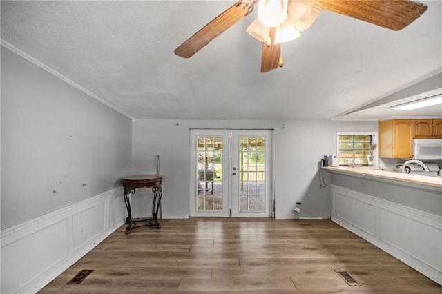 24473 Sanders Rd, Covington, LA 70435 - dining space with french doors, ceiling fan, wood finished floors, lofted ceiling, and crown molding