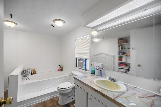 24473 Sanders Rd, Covington, LA 70435 - bathroom featuring a garden tub, vanity, wood finished floors, and a textured ceiling
