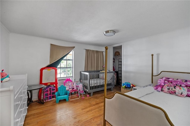 24473 Sanders Rd, Covington, LA 70435 - bedroom with wood finished floors and a textured ceiling