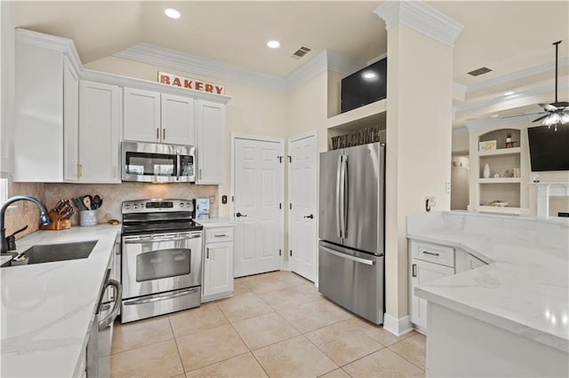 133 Oak Bend Dr, La Place, LA 70068 - kitchen with appliances with stainless steel finishes, ornamental molding, light stone counters, backsplash, and light tile patterned floors
