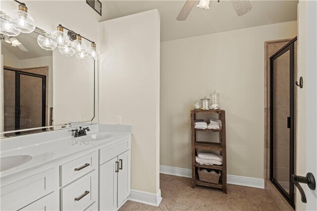 133 Oak Bend Dr, La Place, LA 70068 - bathroom featuring a stall shower, double vanity, a ceiling fan, and tile patterned flooring