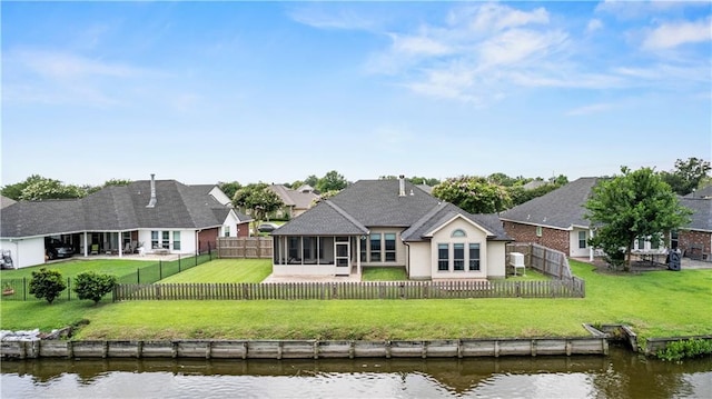 133 Oak Bend Dr, La Place, LA 70068 - back of property featuring a sunroom, a water view, and a fenced backyard