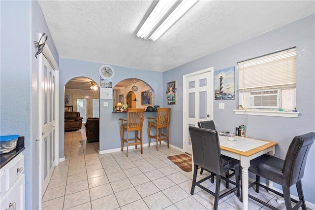 370 Cumberland Dr, Slidell, LA 70458 - dining area with a textured ceiling, arched walkways, light tile patterned floors, and cooling unit