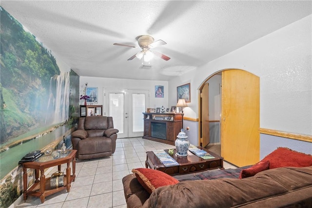 370 Cumberland Dr, Slidell, LA 70458 - living area with tile patterned flooring, arched walkways, a textured ceiling, and a ceiling fan