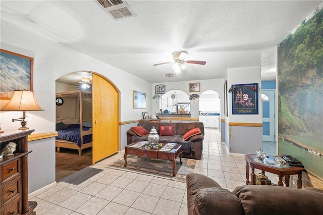 370 Cumberland Dr, Slidell, LA 70458 - living area featuring arched walkways, ceiling fan, tile patterned floors, and a textured ceiling