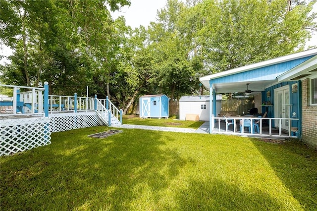 370 Cumberland Dr, Slidell, LA 70458 - view of green lawn featuring a shed, a ceiling fan, a wooden deck, a patio area, and view of wooded area