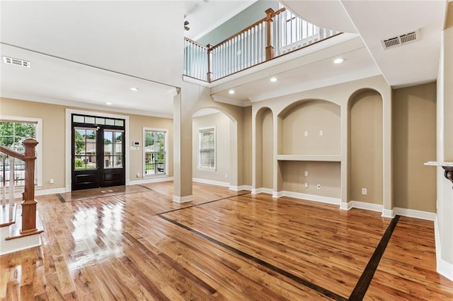 4953 Music St, New Orleans, LA 70122 - entrance foyer featuring light wood-style flooring, ornamental molding, a towering ceiling, stairs, and recessed lighting