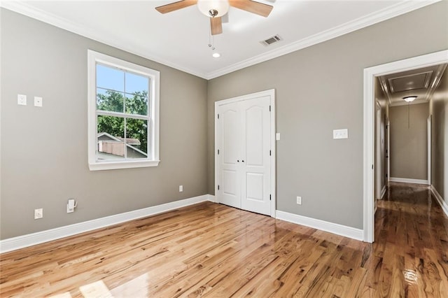 4953 Music St, New Orleans, LA 70122 - unfurnished bedroom with attic access, wood finished floors, ornamental molding, a ceiling fan, and a closet