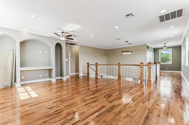4953 Music St, New Orleans, LA 70122 - spare room with ornamental molding, recessed lighting, light wood finished floors, ceiling fan, and arched walkways