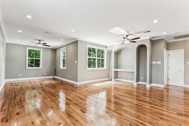 4953 Music St, New Orleans, LA 70122 - unfurnished living room with a ceiling fan, ornamental molding, recessed lighting, light wood-type flooring, and arched walkways