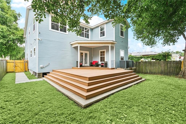 4953 Music St, New Orleans, LA 70122 - rear view of house featuring a fenced backyard, a deck, and a gate
