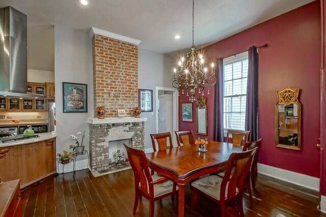 1025 General Pershing St, New Orleans, LA 70115 - dining area with dark wood finished floors, a chandelier, recessed lighting, and a fireplace