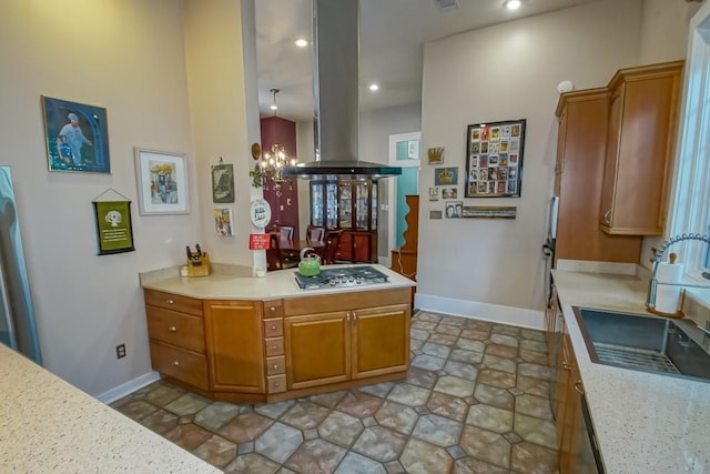 1025 General Pershing St, New Orleans, LA 70115 - kitchen featuring island exhaust hood, light countertops, brown cabinets, stainless steel gas stovetop, and recessed lighting