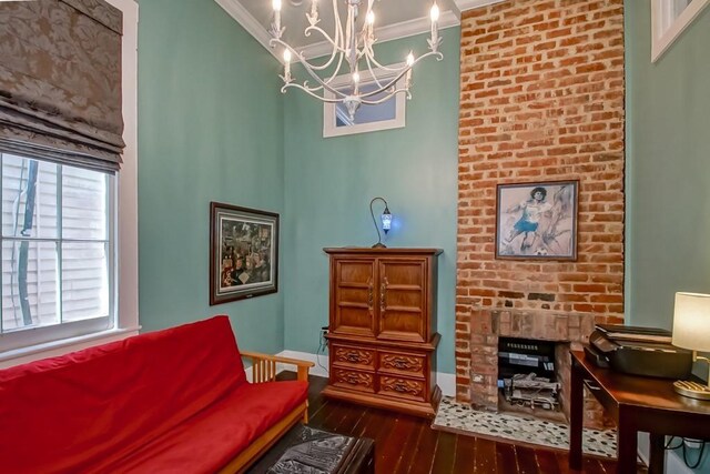 1025 General Pershing St, New Orleans, LA 70115 - living area featuring crown molding, a chandelier, dark wood-type flooring, and a fireplace