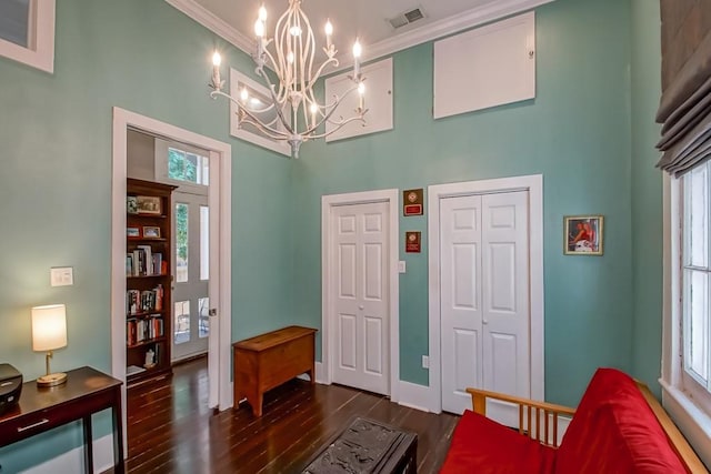 1025 General Pershing St, New Orleans, LA 70115 - living area with a high ceiling, a chandelier, dark wood-type flooring, healthy amount of natural light, and ornamental molding