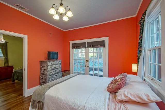 1025 General Pershing St, New Orleans, LA 70115 - bedroom with a chandelier, french doors, wood finished floors, and crown molding