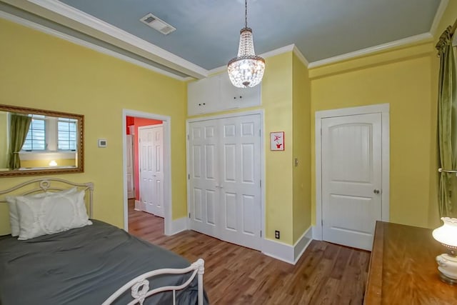 1025 General Pershing St, New Orleans, LA 70115 - bedroom with wood finished floors, ornamental molding, and a chandelier