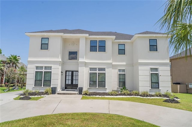 251 Oakmont Dr, New Orleans, LA 70128 - view of front of home featuring french doors, stucco siding, and a front lawn