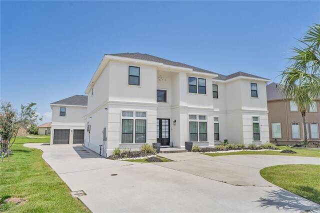 251 Oakmont Dr, New Orleans, LA 70128 - view of front of home with concrete driveway, stucco siding, an attached garage, and a front lawn