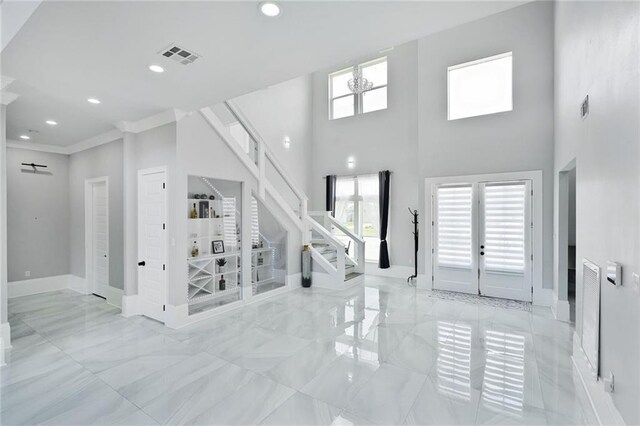 251 Oakmont Dr, New Orleans, LA 70128 - entryway featuring marble finish floors, stairway, recessed lighting, crown molding, and a high ceiling