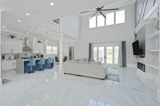 251 Oakmont Dr, New Orleans, LA 70128 - living area with crown molding, a ceiling fan, french doors, light marble finish floors, and recessed lighting