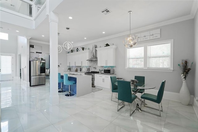251 Oakmont Dr, New Orleans, LA 70128 - dining area with crown molding, a chandelier, light marble finish floors, recessed lighting, and decorative columns