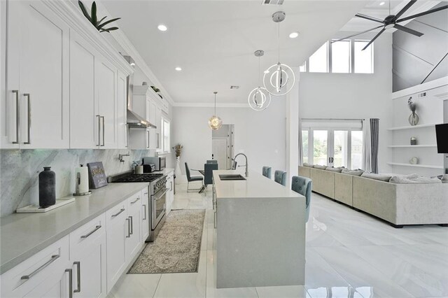 251 Oakmont Dr, New Orleans, LA 70128 - kitchen featuring stainless steel stove, white cabinets, plenty of natural light, ceiling fan, and ornamental molding