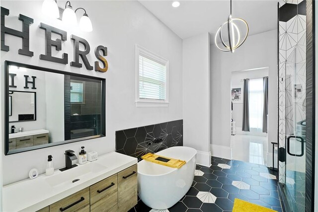 251 Oakmont Dr, New Orleans, LA 70128 - bathroom with a stall shower, vanity, a freestanding tub, and tile patterned flooring