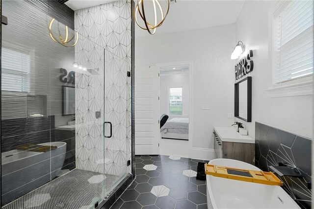 251 Oakmont Dr, New Orleans, LA 70128 - ensuite bathroom with a freestanding tub, vanity, a shower stall, and tile patterned flooring