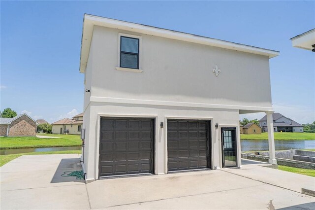 251 Oakmont Dr, New Orleans, LA 70128 - garage with a water view and concrete driveway