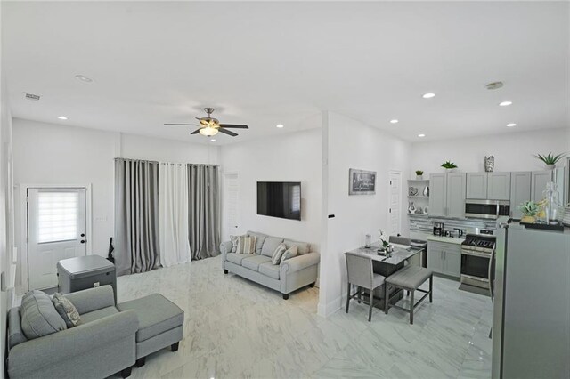 251 Oakmont Dr, New Orleans, LA 70128 - living area with recessed lighting, ceiling fan, and light marble finish flooring