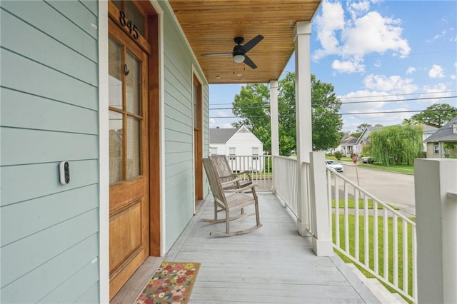 845 Pontalba St, New Orleans, LA 70124 - wooden porch with ceiling fan and a residential view
